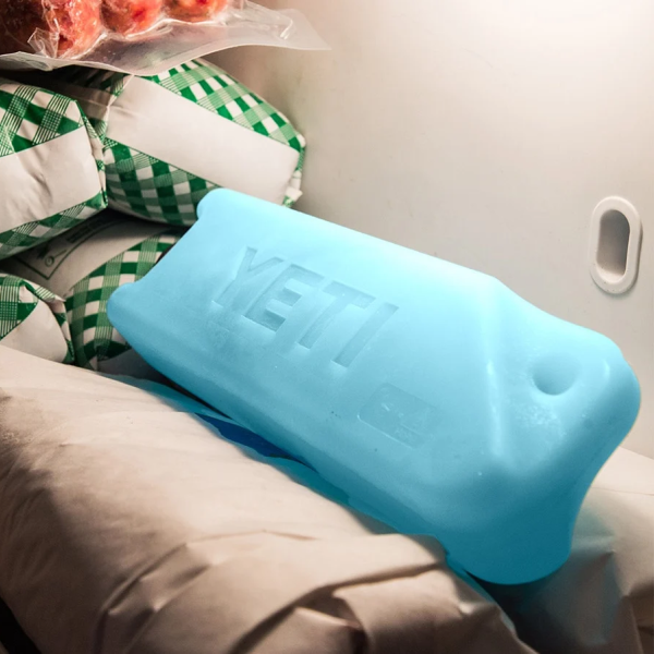 Blue YETI Ice Block resting on a seat in a vehicle