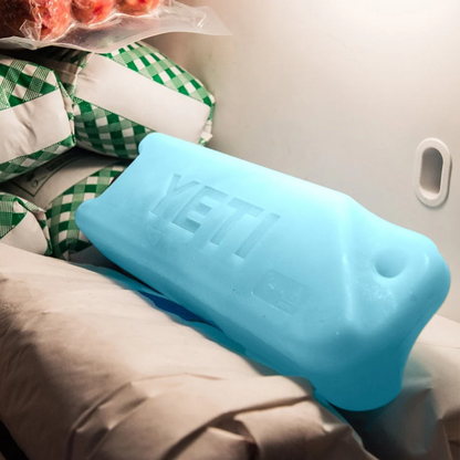 Blue YETI Ice Block resting on a seat in a vehicle