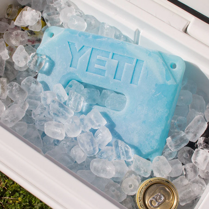 Blue YETI Ice Block sitting on ice inside a white cool box
